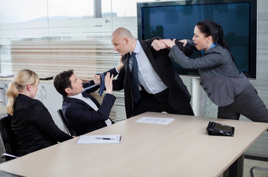 employee being terminated jumping across conference table to attack another employee